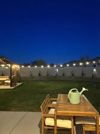 a view of a chairs and table in patio