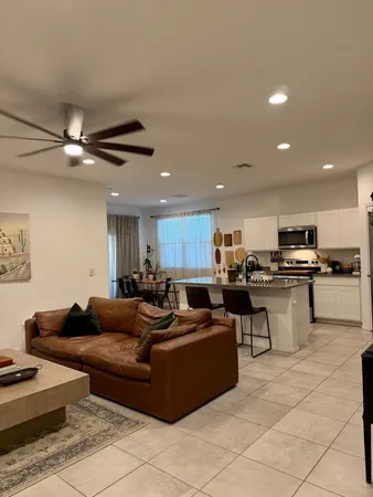 a living room with furniture and kitchen view