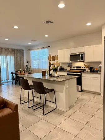 a kitchen with cabinets a sink and appliances