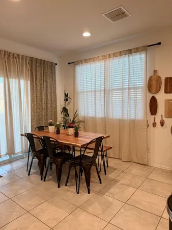 a view of a dining room with furniture and chandelier