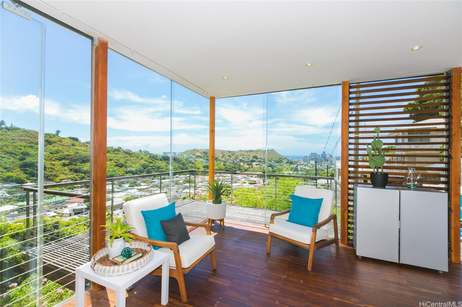 2455 Pacific Heights Road, Unit E Honolulu, HI 96813 - Photo 1 of 1 a living room with patio furniture and a floor to ceiling window