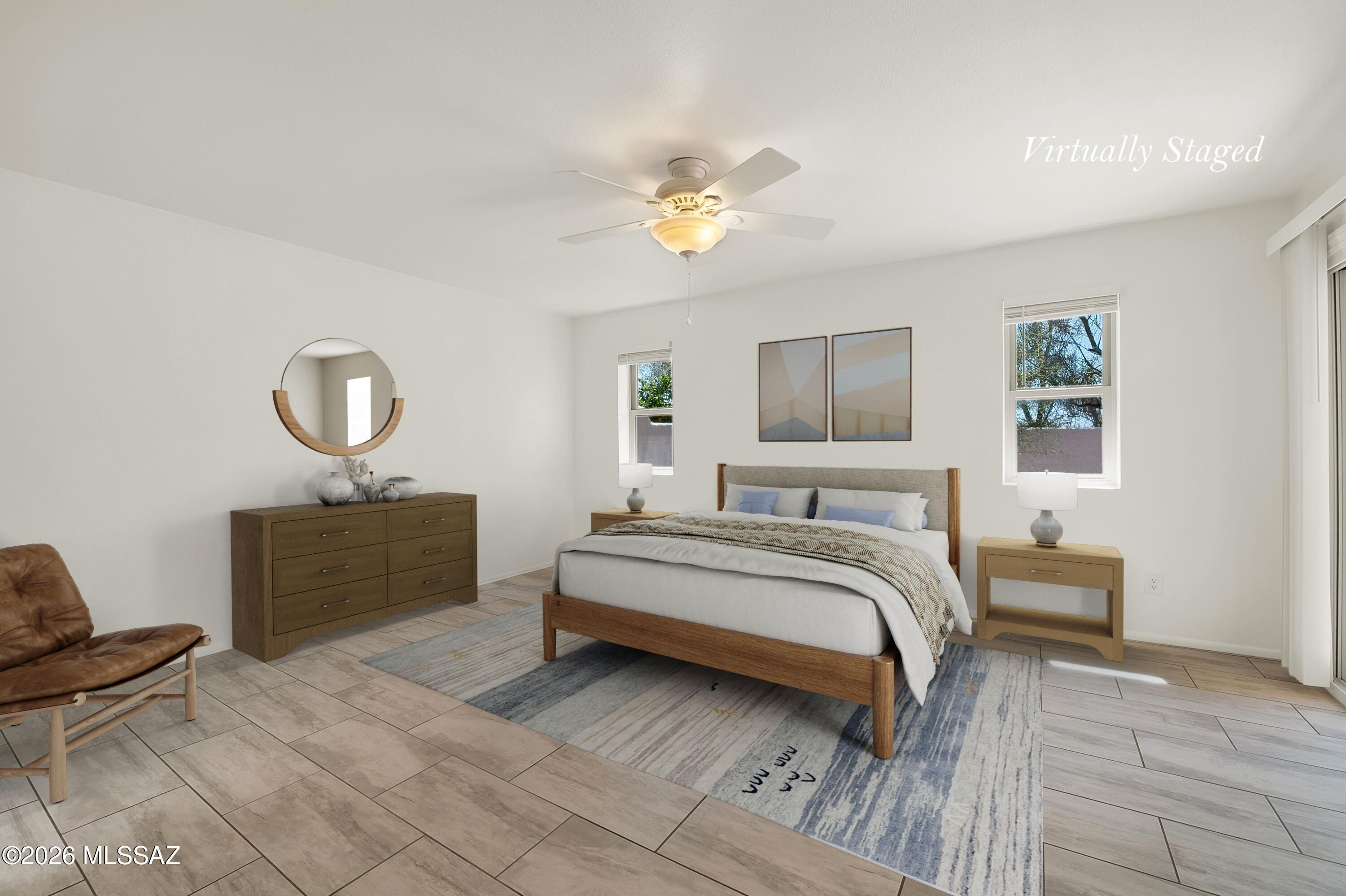 7408 East Wandering Road Tucson, AZ 85750 - Photo 13 of 25 a bedroom with a bed and a chandelier