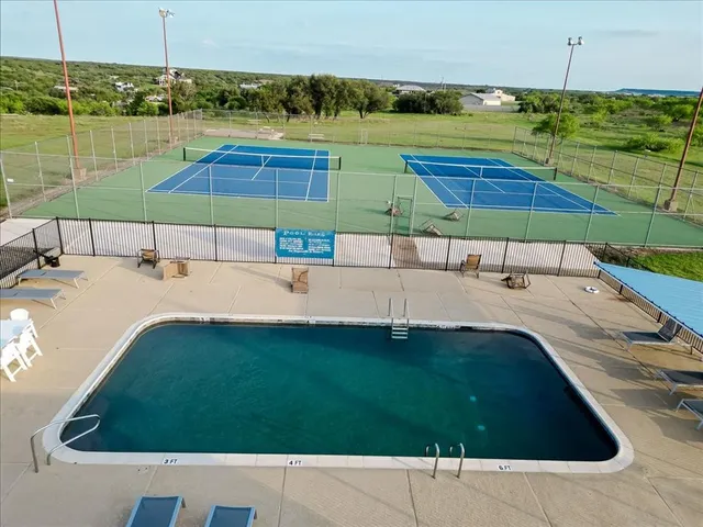 a view of a swimming pool with a yard