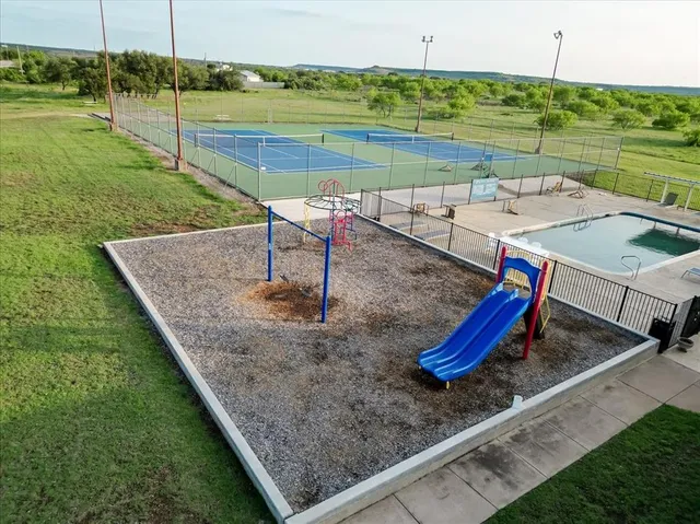 a view of a backyard with swimming pool