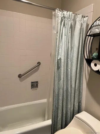 a bathroom with a shower and a sink