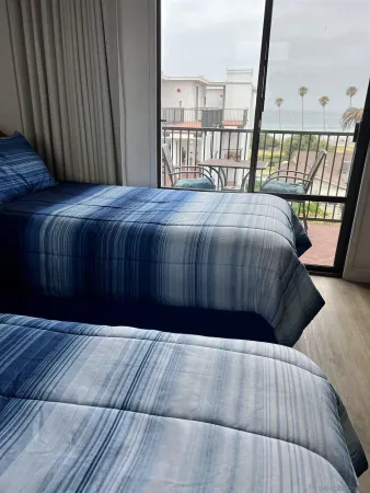 a bed sitting in a bedroom next to a window