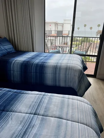 a bed sitting in a bedroom next to a window