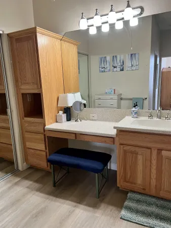 a room with a bed furniture and a mirror