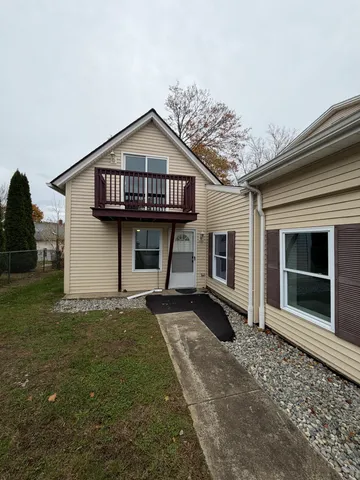 a view of a house with a yard and large windows