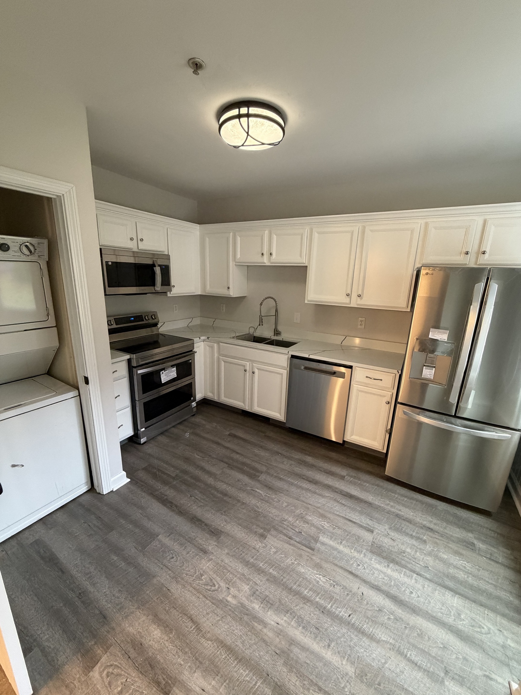 34 Pleasant Street, Unit 3 Plainfield, CT 06374 - Photo 3 of 10 a kitchen with granite countertop a refrigerator and a stove top oven