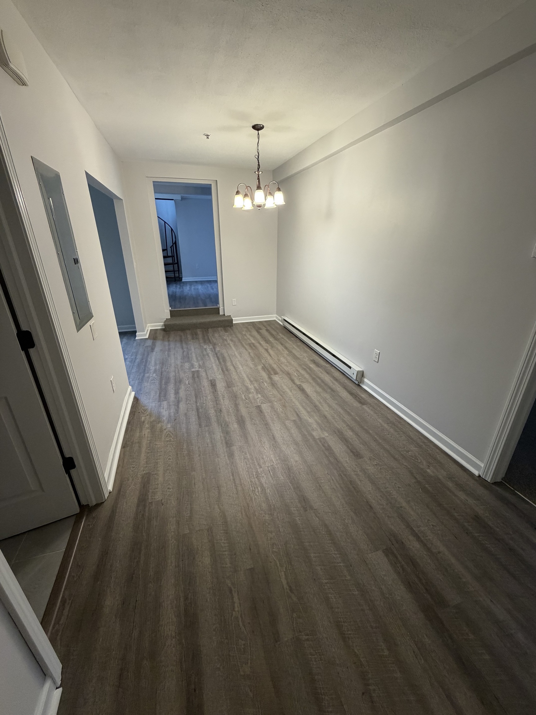 34 Pleasant Street, Unit 3 Plainfield, CT 06374 - Photo 4 of 10 an empty room with wooden floor and windows