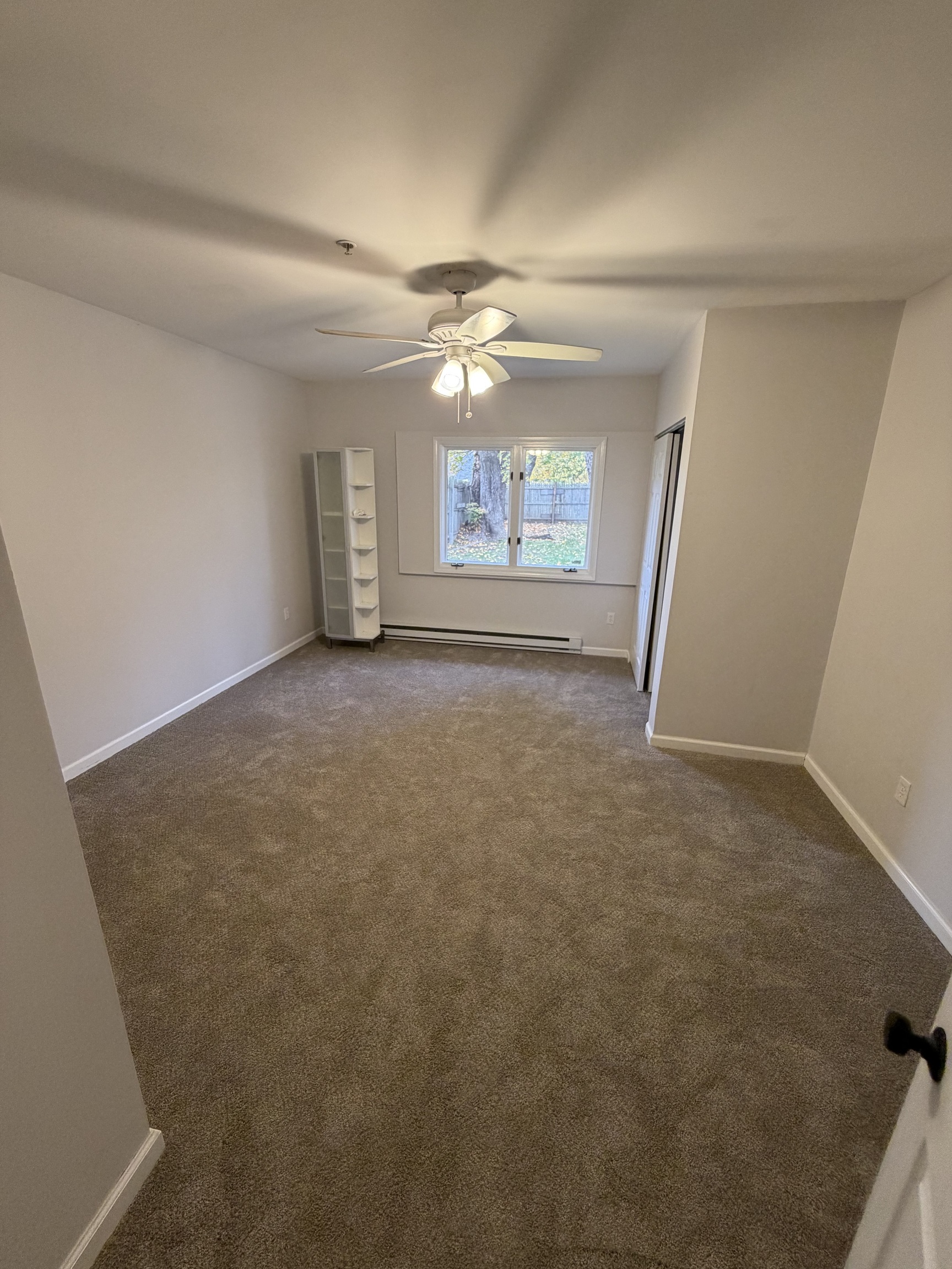 34 Pleasant Street, Unit 3 Plainfield, CT 06374 - Photo 5 of 10 en empty room with windows and ceiling fan