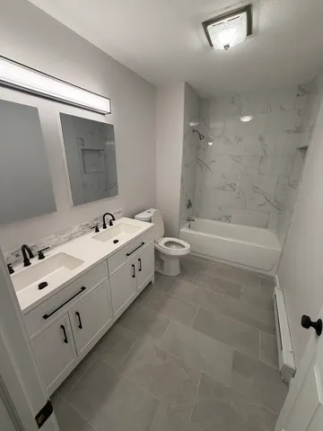 a bathroom with a bathtub sink and toilet