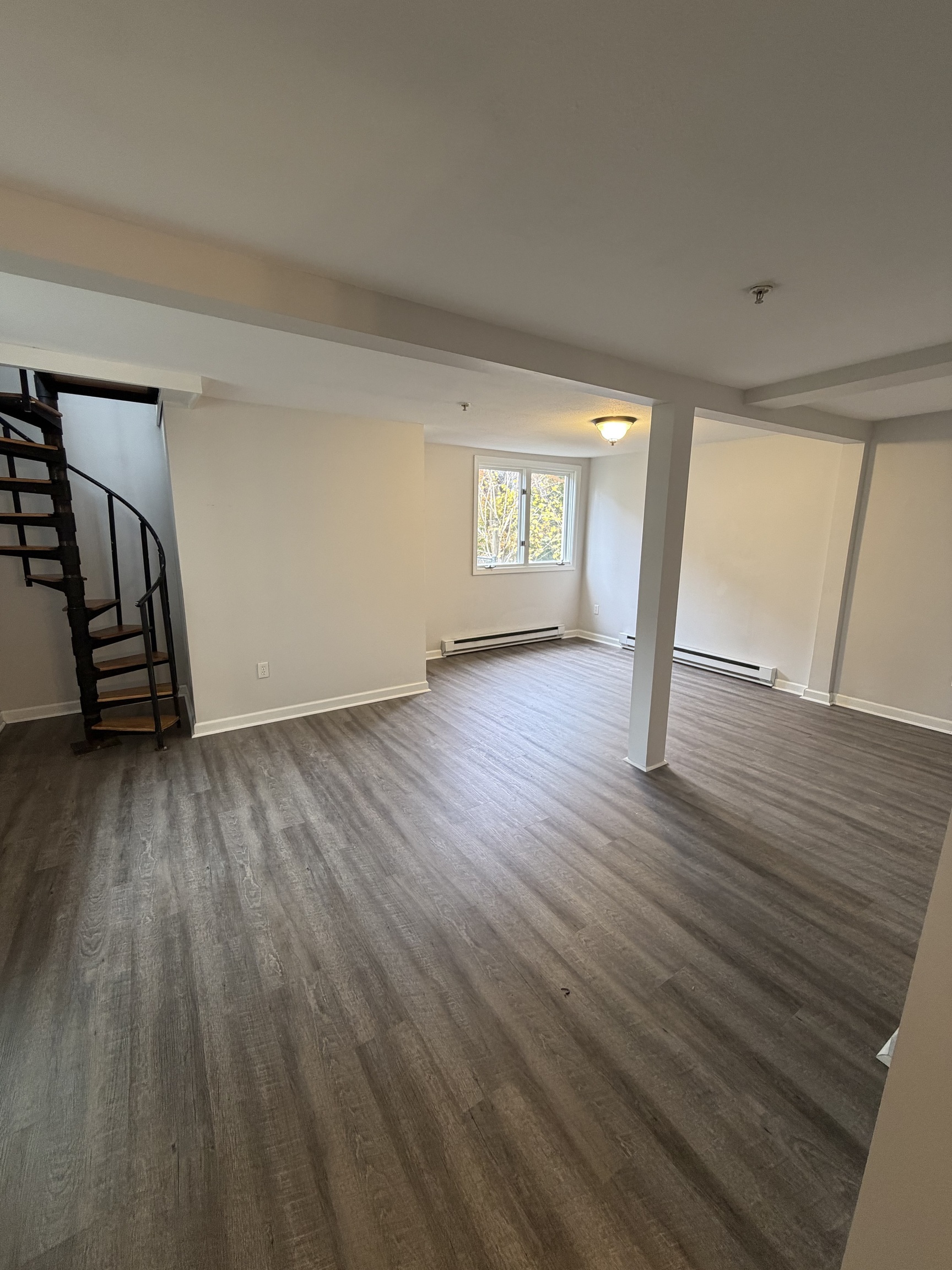 34 Pleasant Street, Unit 3 Plainfield, CT 06374 - Photo 7 of 10 a view of an empty room with wooden floor and a window