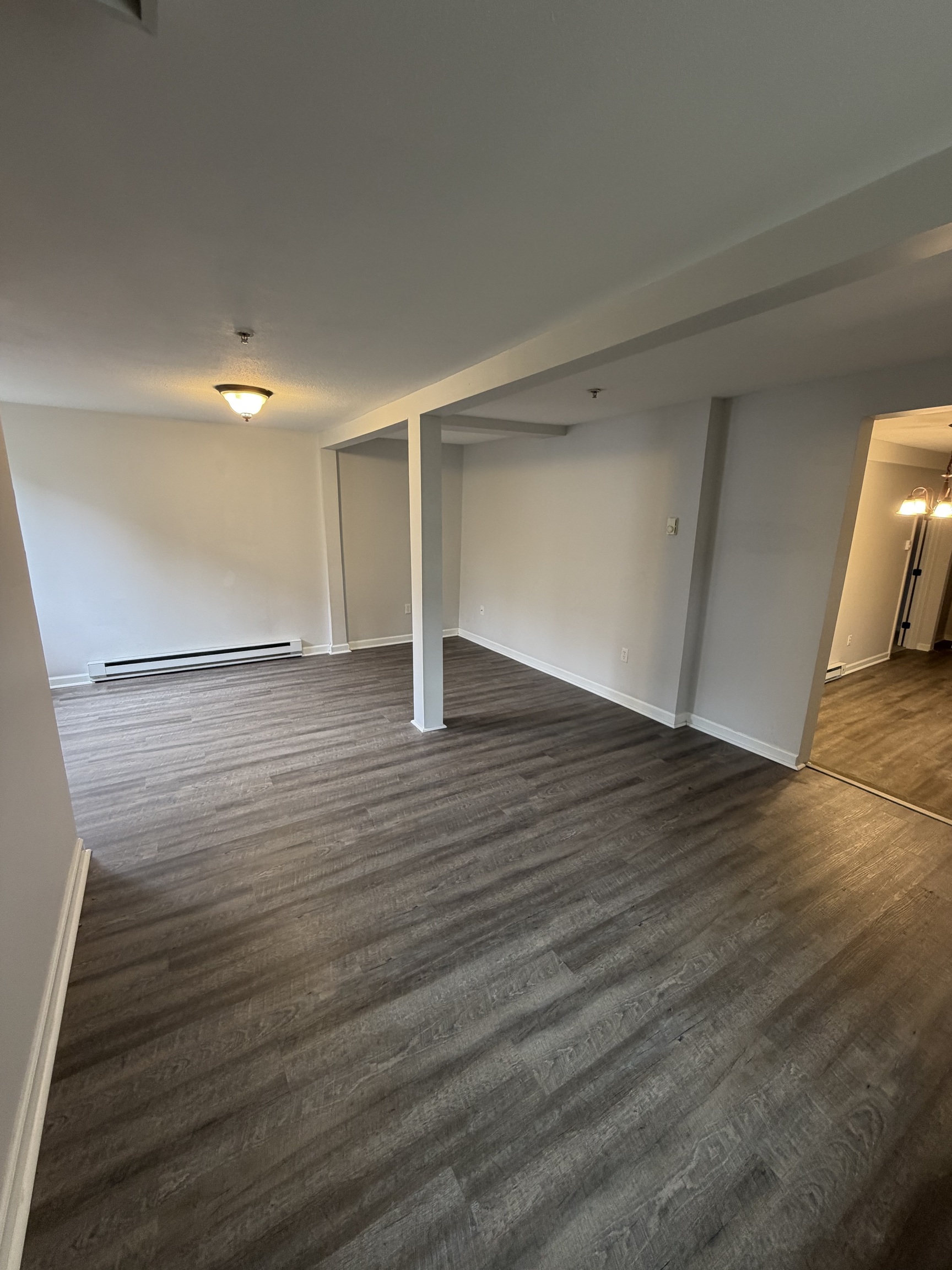 34 Pleasant Street, Unit 3 Plainfield, CT 06374 - Photo 8 of 10 a view of an empty room with wooden floor