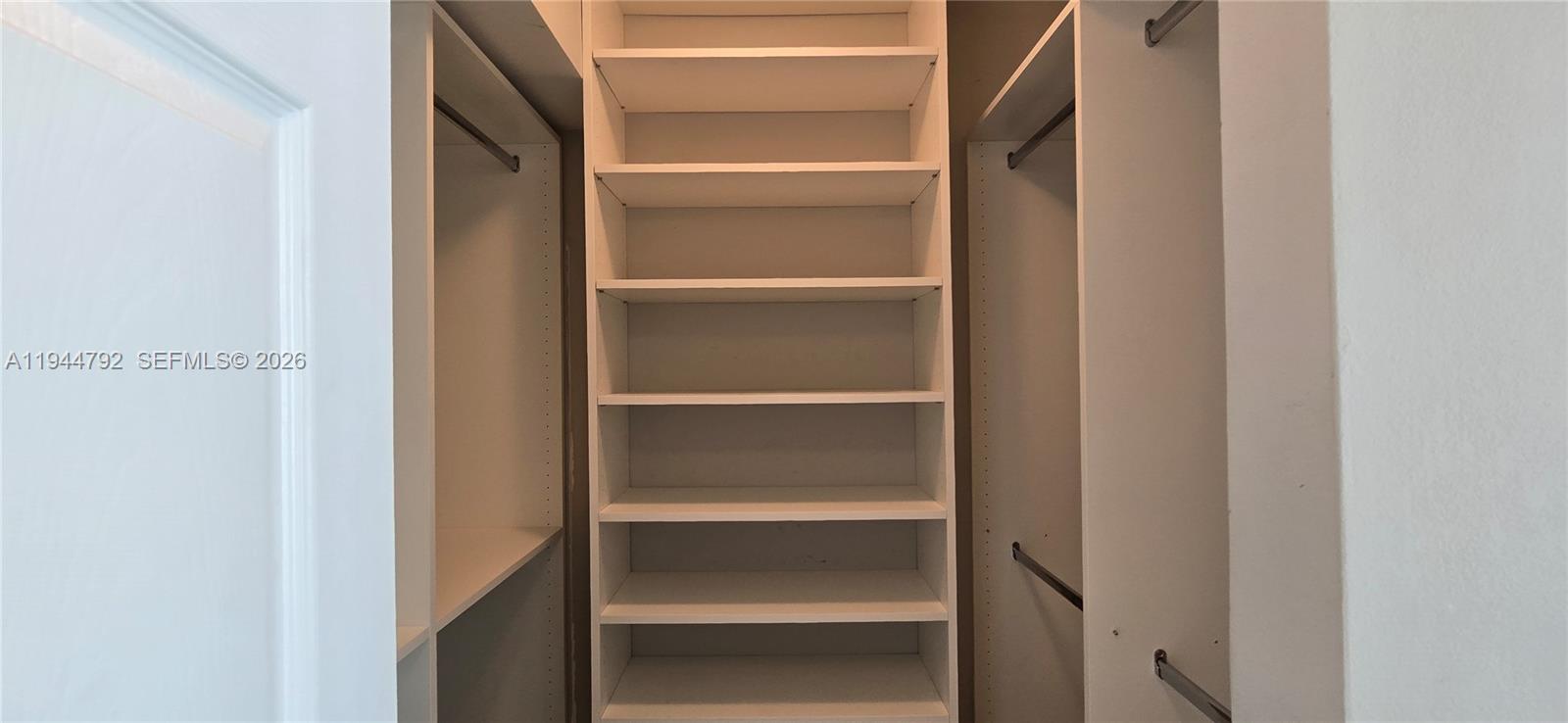 600 Northeast 36th Street, Unit 1509 Miami, FL 33137 - Photo 11 of 21 a view of walk in closet with empty racks