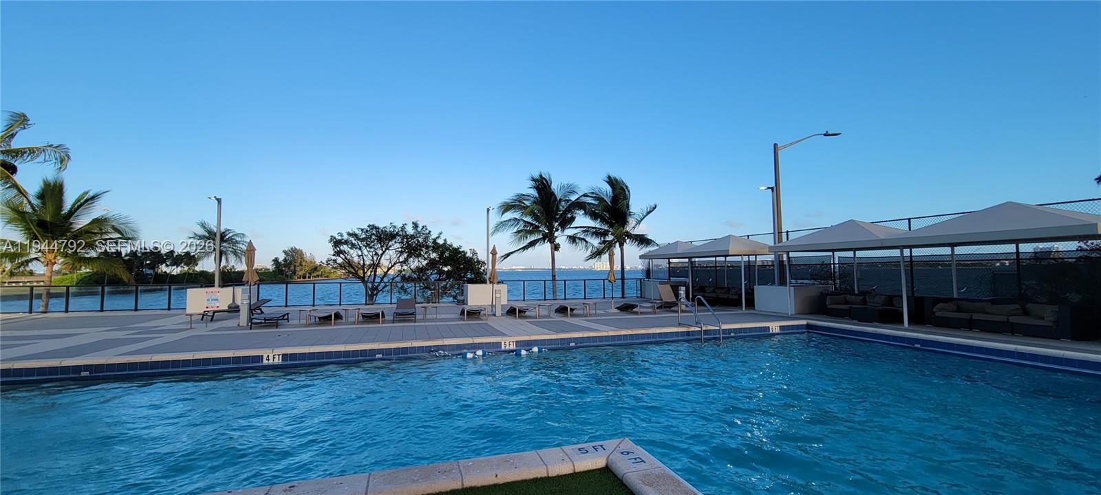 600 Northeast 36th Street, Unit 1509 Miami, FL 33137 - Photo 17 of 21 a backyard of a house with table and chairs
