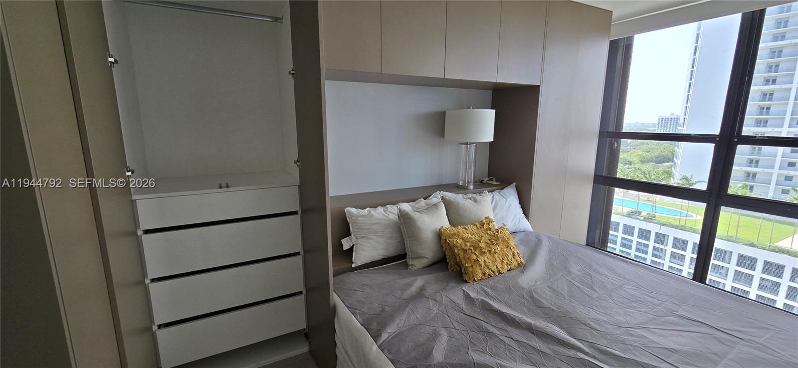 600 Northeast 36th Street, Unit 1509 Miami, FL 33137 - Photo 8 of 21 a bedroom with a bed and large window