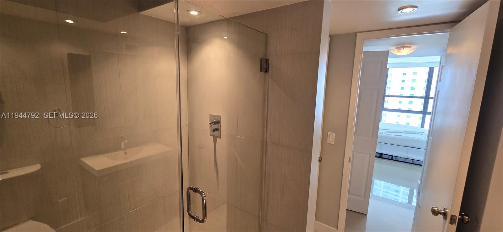 600 Northeast 36th Street, Unit 1509 Miami, FL 33137 - Photo 9 of 21 a bathroom with a shower and a glass door