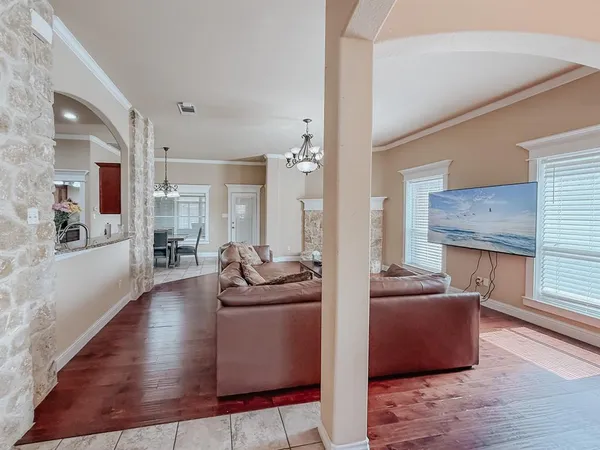 a living room with furniture window and wooden floor