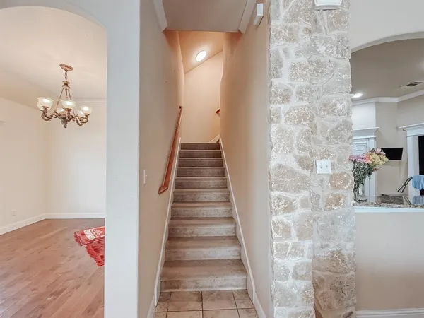 a view of a hallway with wooden floor and staircase