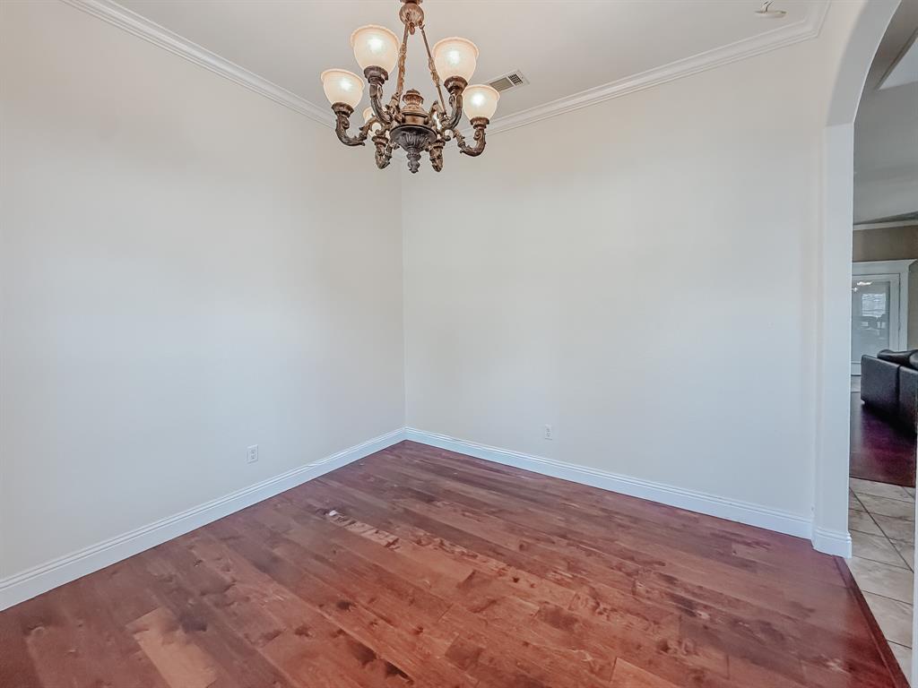 100 Timbershade Drive Red Oak, TX 75154 - Photo 16 of 38 a view of a hallway with wooden floor and a chandelier