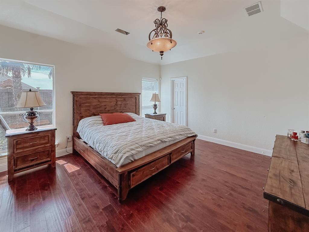 100 Timbershade Drive Red Oak, TX 75154 - Photo 19 of 38 a bedroom with a bed and wooden floor