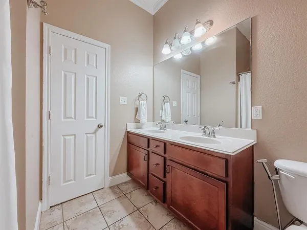 a bathroom with a double vanity sink and a mirror