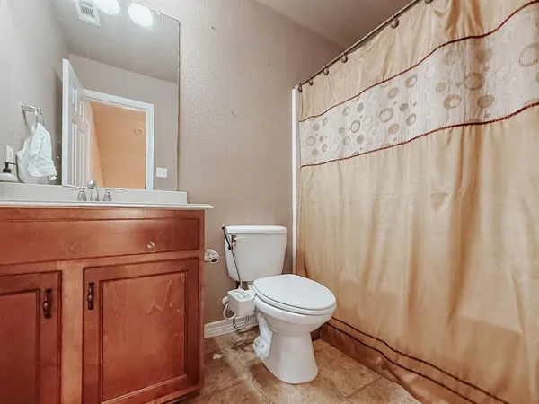 a bathroom with a toilet a sink and a mirror