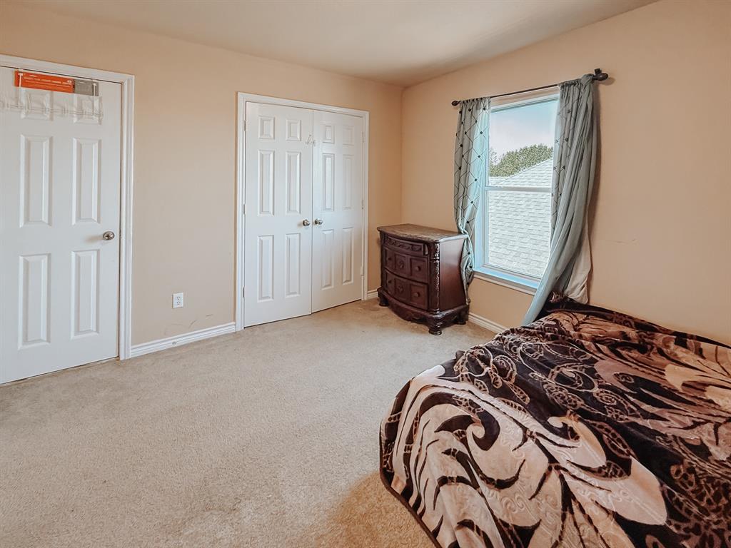 100 Timbershade Drive Red Oak, TX 75154 - Photo 28 of 38 a bedroom with a bed and a window