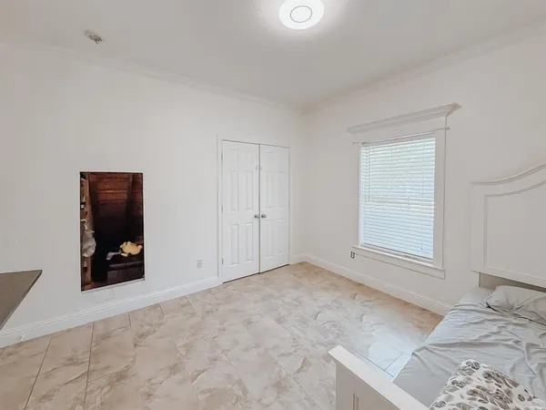 an empty room with window and furniture