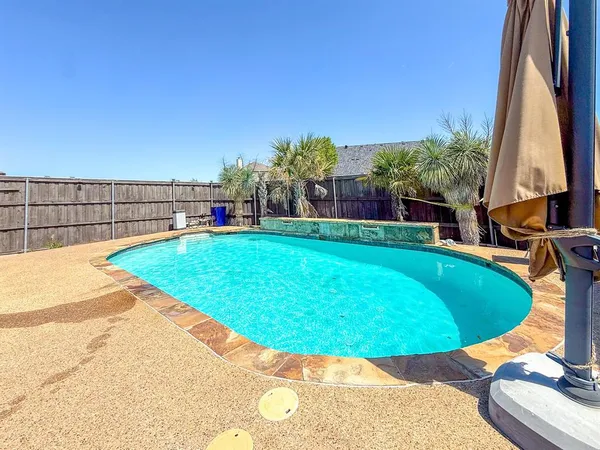 a view of a swimming pool with a backyard