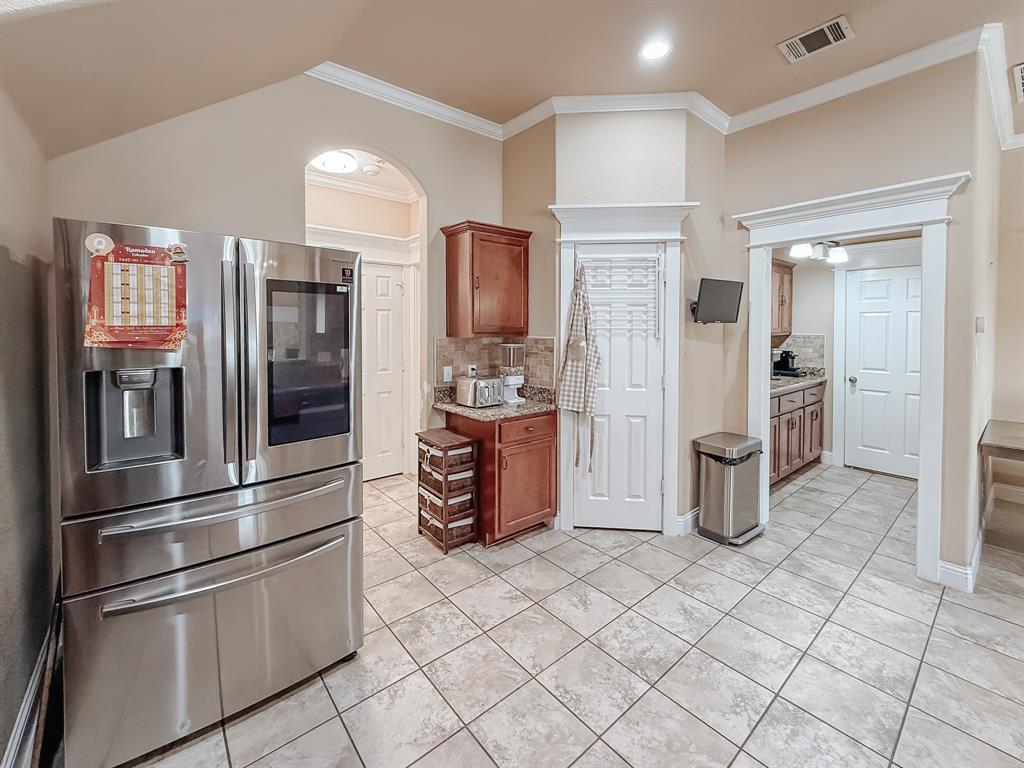 100 Timbershade Drive Red Oak, TX 75154 - Photo 5 of 38 a kitchen with stainless steel appliances a refrigerator and a stove top oven