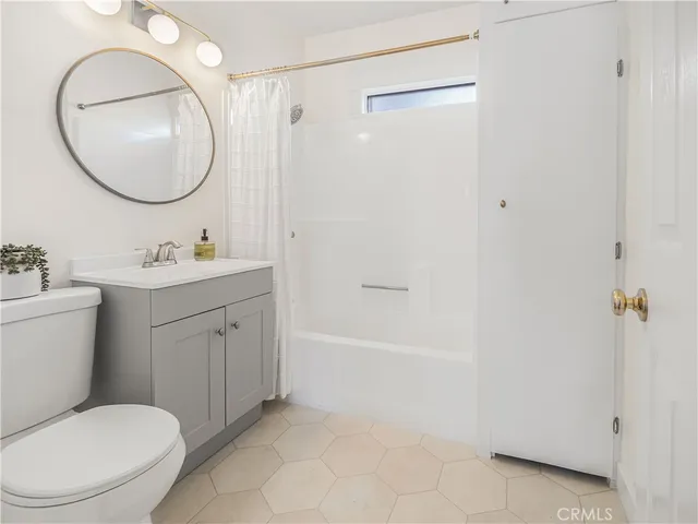 a bathroom with a sink toilet and a mirror