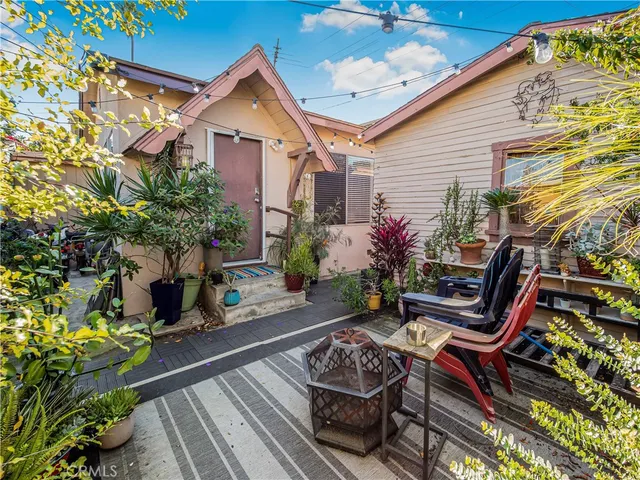 a view of a chairs and tables in the back yard of the house