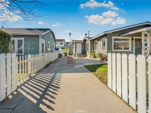a view of a house with wooden fence