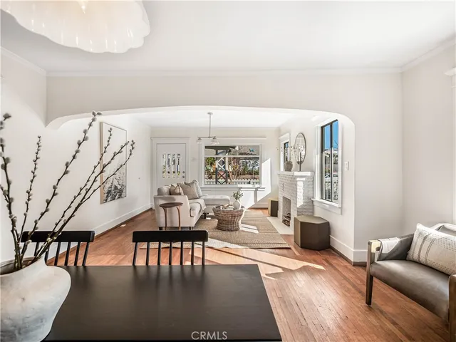 a living room with furniture wooden floor and a table