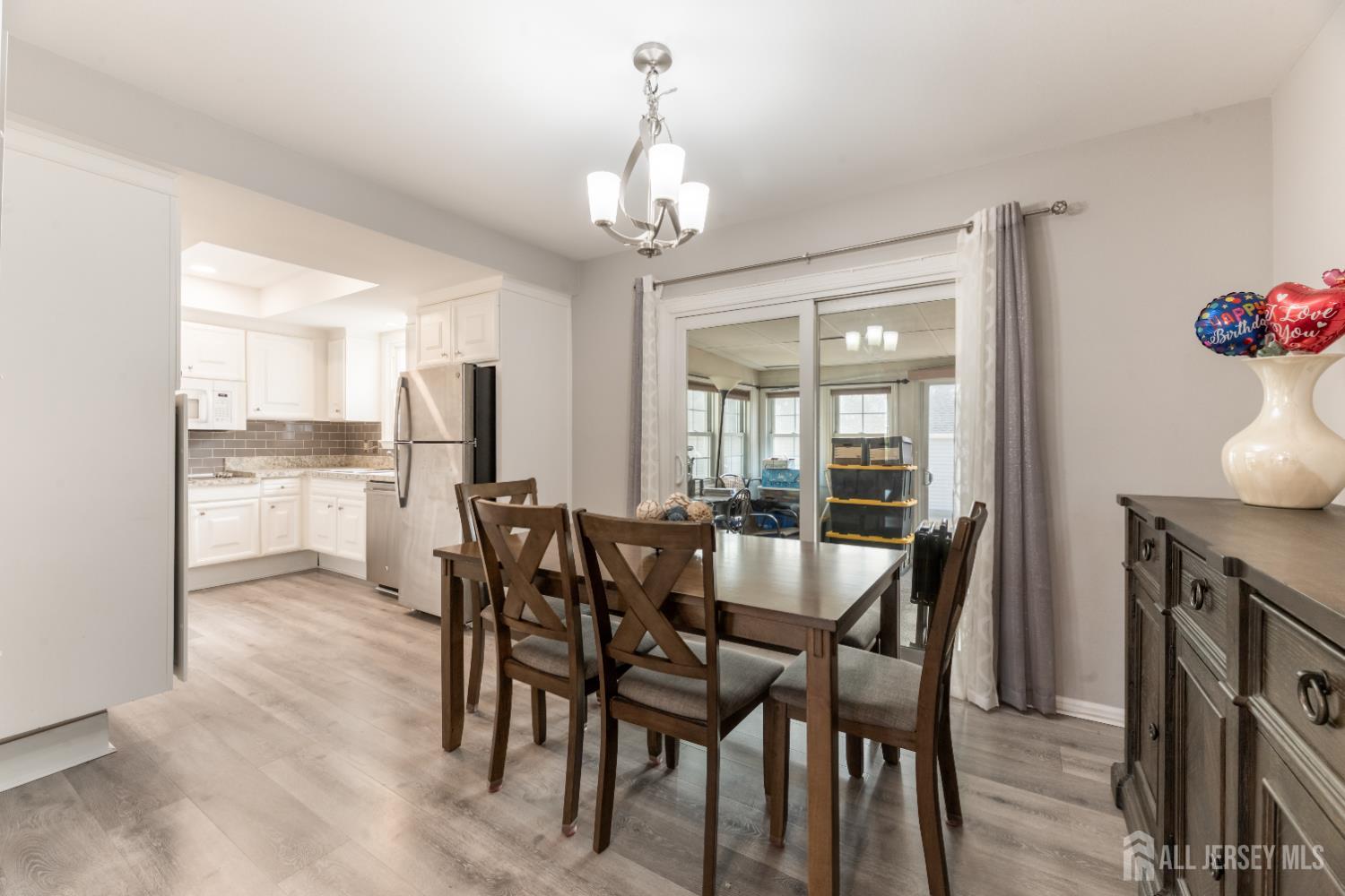 94 Gloucester Way, Unit B Monroe Township, NJ 08831 - Photo 6 of 20 a view of a dining room with furniture window and wooden floor
