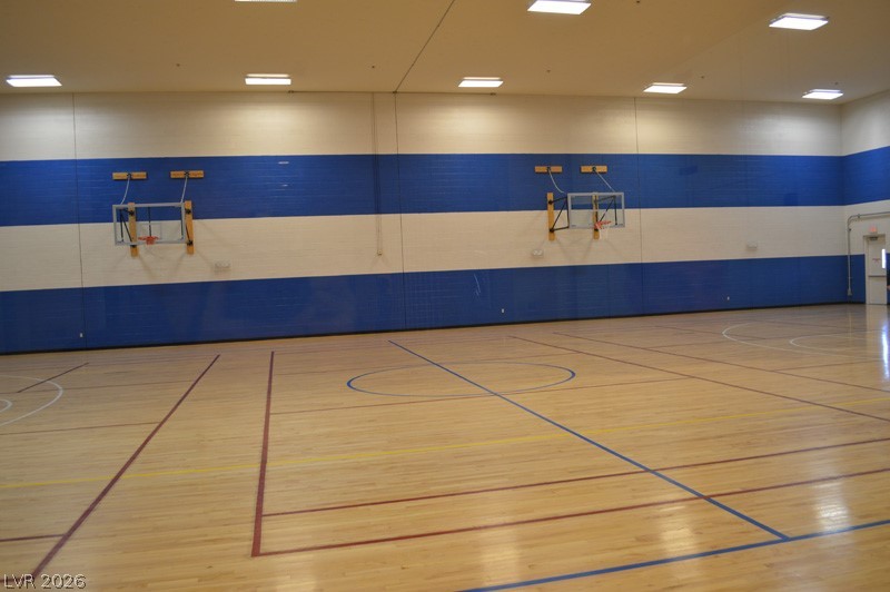 87 Tall Ruff Drive Las Vegas, NV 89148 - Photo 21 of 71 An indoor sports court featuring polished hardwood floors and dual basketball hoops.