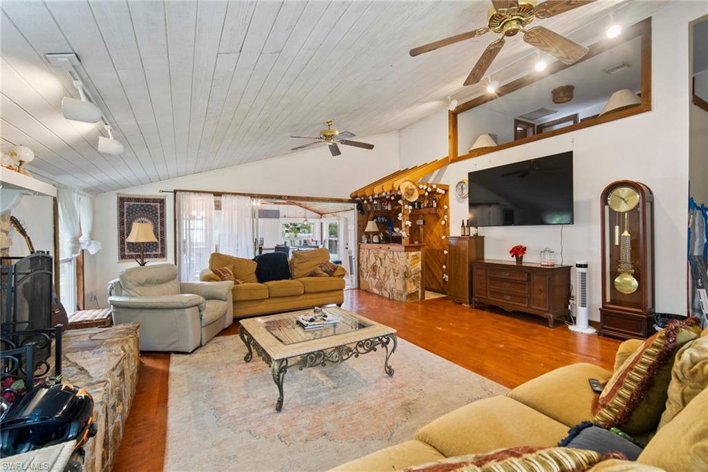 19883 Bristol Road Fort Myers, FL 33908 - Photo 7 of 25 Living room with hardwood / wood-style flooring, ceiling fan, vaulted ceiling, and rail lighting