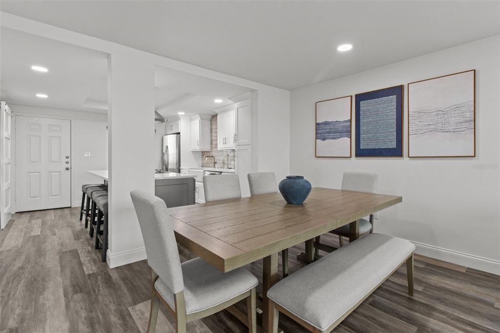 14950 Gulf Boulevard, Unit 503 Madeira Beach, FL 33708 - Photo 12 of 43 a view of a dining room with furniture and wooden floor
