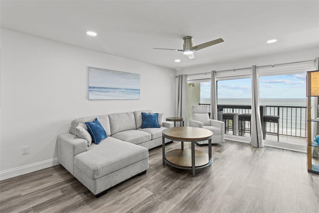 14950 Gulf Boulevard, Unit 503 Madeira Beach, FL 33708 - Photo 13 of 43 a living room with furniture and a large window