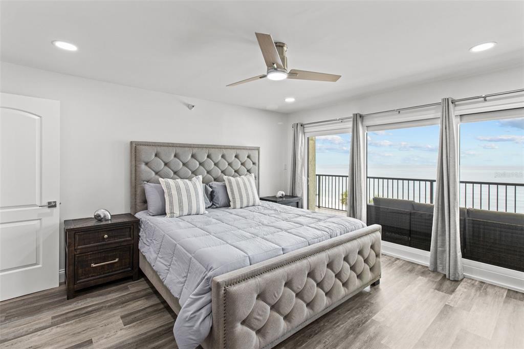 14950 Gulf Boulevard, Unit 503 Madeira Beach, FL 33708 - Photo 18 of 43 a bedroom with a bed and a large window