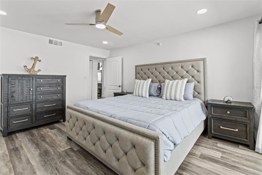 14950 Gulf Boulevard, Unit 503 Madeira Beach, FL 33708 - Photo 19 of 43 a bedroom with a bed and a dresser