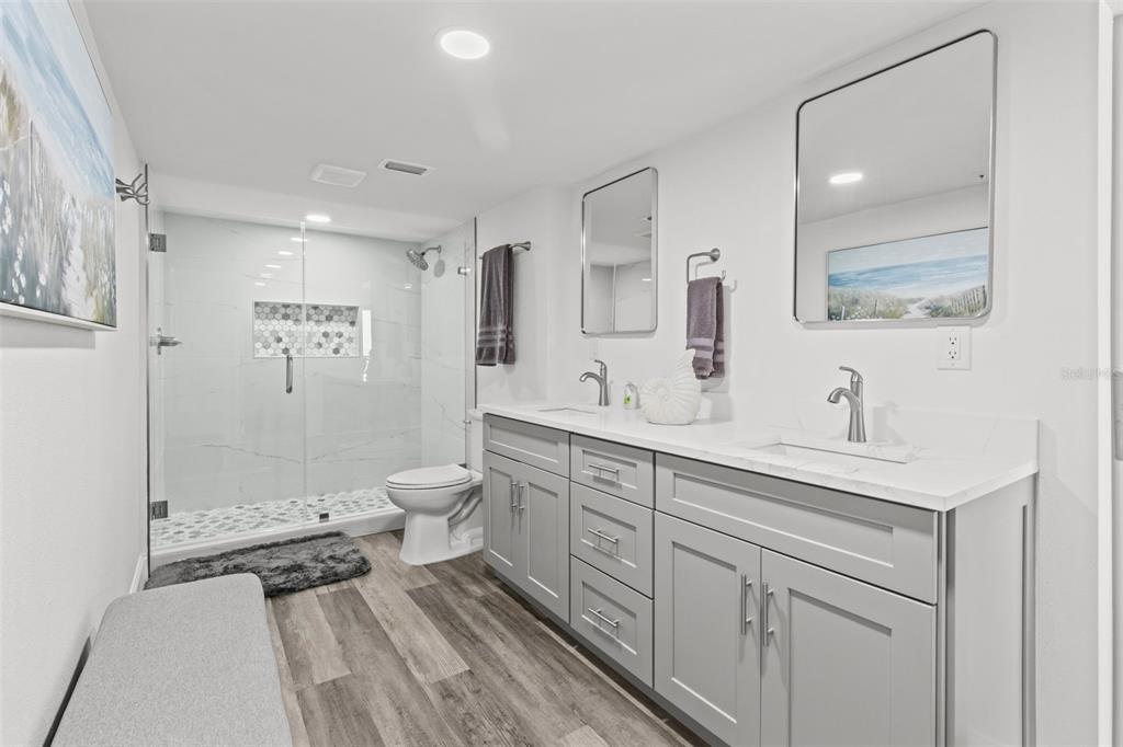 14950 Gulf Boulevard, Unit 503 Madeira Beach, FL 33708 - Photo 20 of 43 a spacious bathroom with a shower sink mirror and toilet