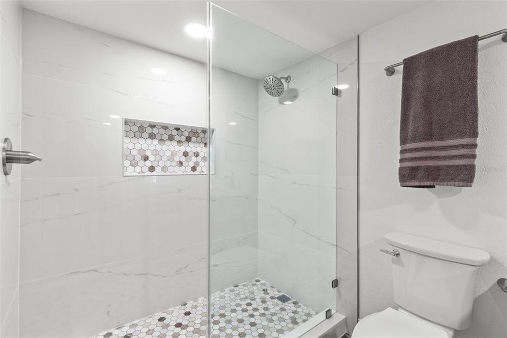 14950 Gulf Boulevard, Unit 503 Madeira Beach, FL 33708 - Photo 21 of 43 a bathroom with a shower and a toilet