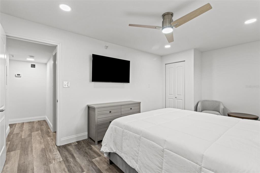 14950 Gulf Boulevard, Unit 503 Madeira Beach, FL 33708 - Photo 24 of 43 a bedroom with a bed and a flat screen tv