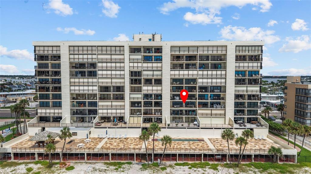 14950 Gulf Boulevard, Unit 503 Madeira Beach, FL 33708 - Photo 36 of 43 a front view of a building with glass windows
