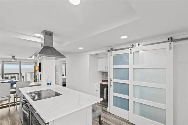 a kitchen with stainless steel appliances a stove a sink a refrigerator and cabinets