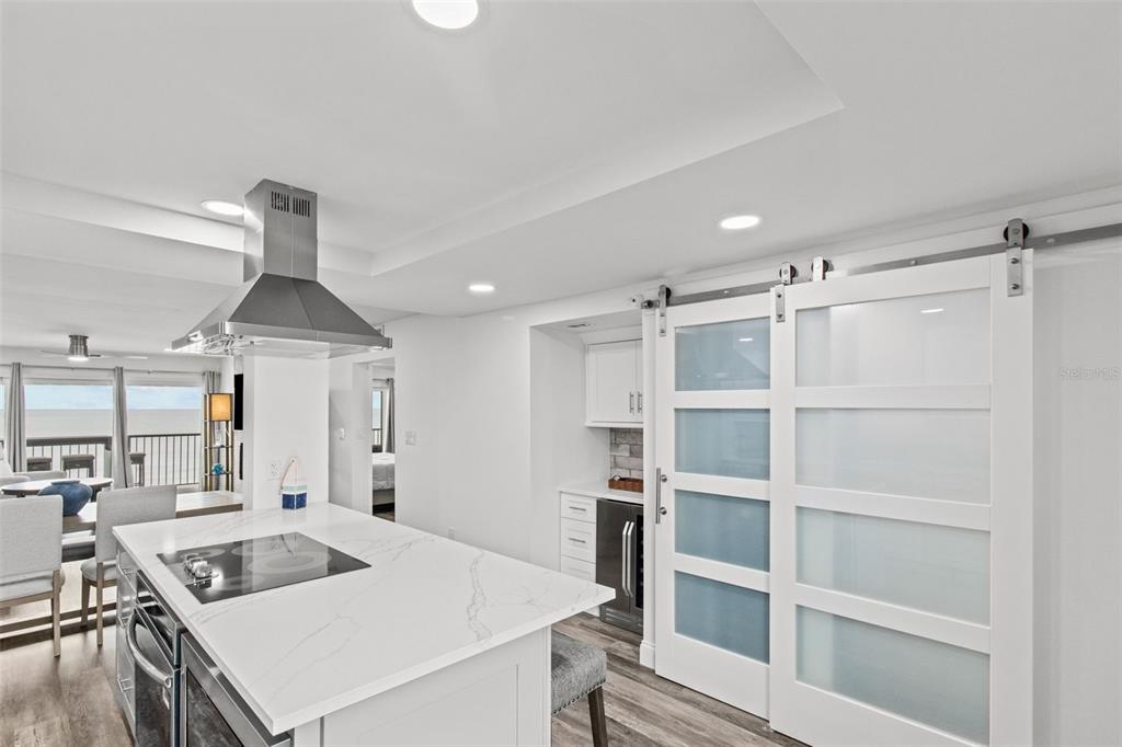 14950 Gulf Boulevard, Unit 503 Madeira Beach, FL 33708 - Photo 8 of 43 a kitchen with a stove a refrigerator and a sink with wooden floor